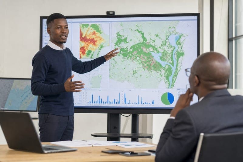Student presenting a geospatial capstone project during a graduation assessment